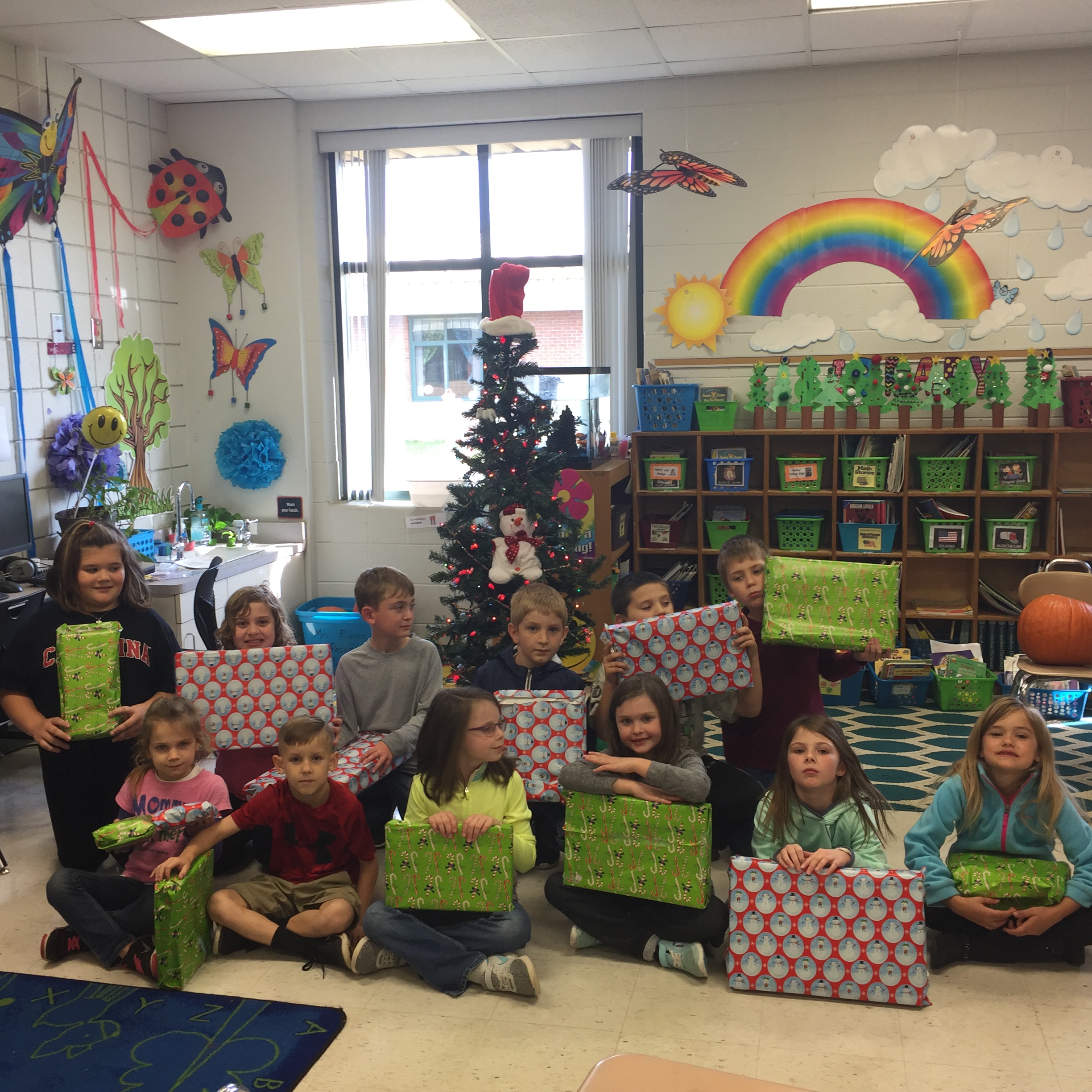 Mrs Eaves second grade class holding gifts for a special child this Christmas
