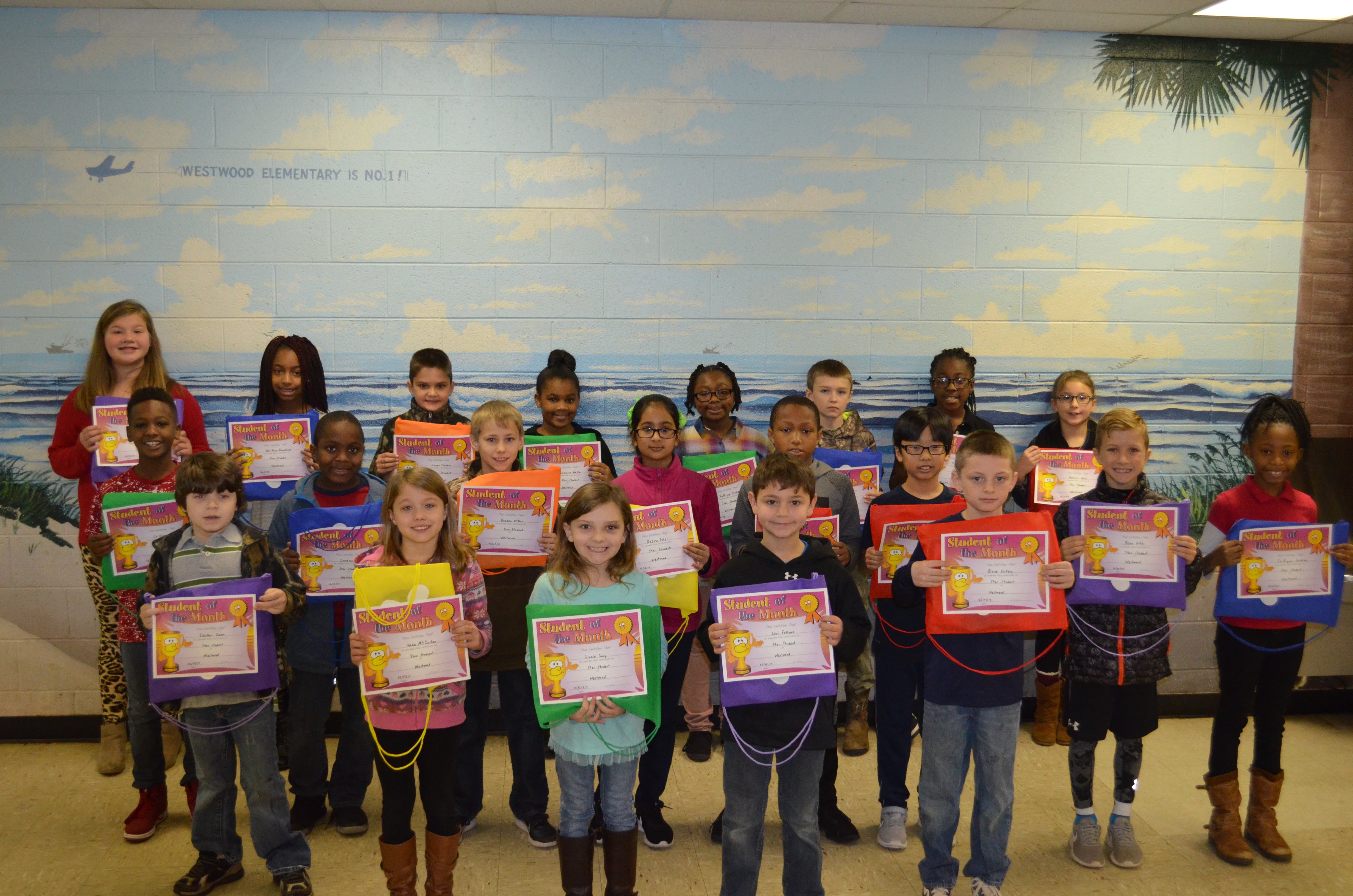 westwood star students for december holding certificates